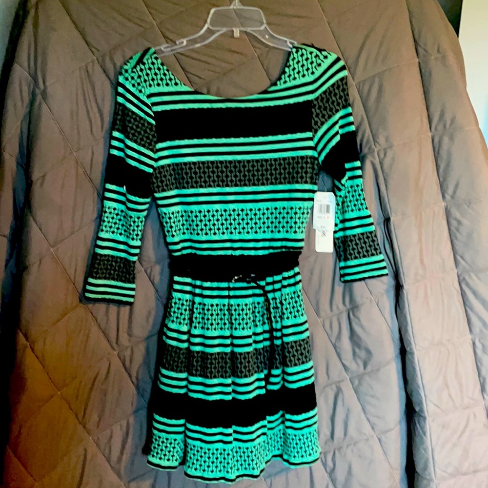 Long sleeve mini dress. Loose fit very chic and professional. Has an open back.